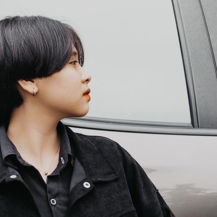 Alex Kim, Lead Design Curator at Silent River Guide, reviewing corporate floral arrangements